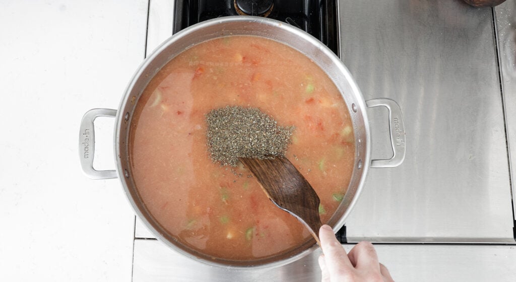 Stirring basil into pot