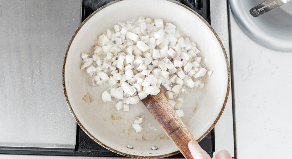 White fish in pan turning slightly brown