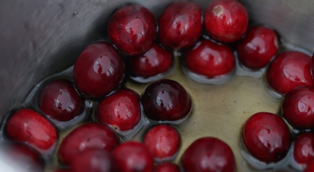 cranberries in the pot with syrup