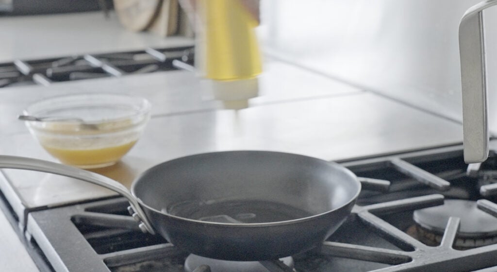 Adding oil to pan on a stove