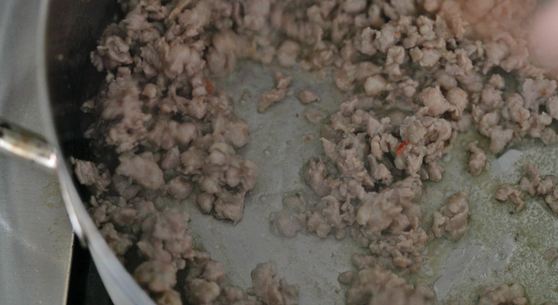 cooking sausage in a pan