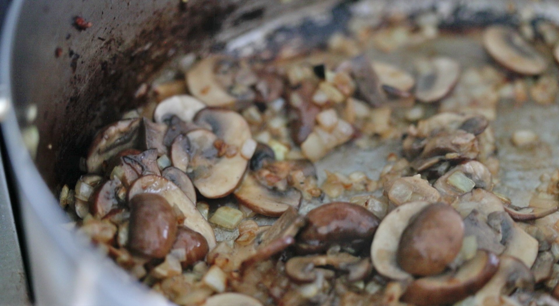 saut&eacute;ed mushrooms in a pan