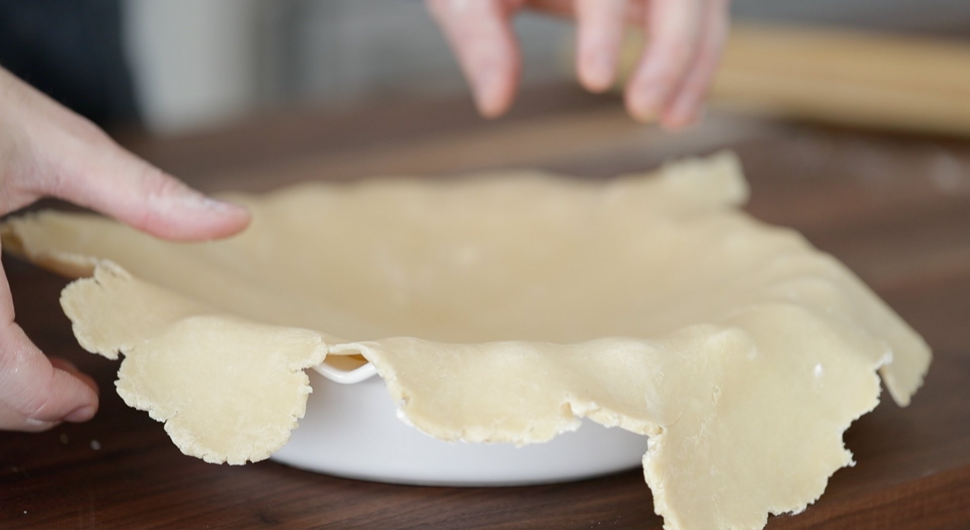 placing dough onto a pie pan