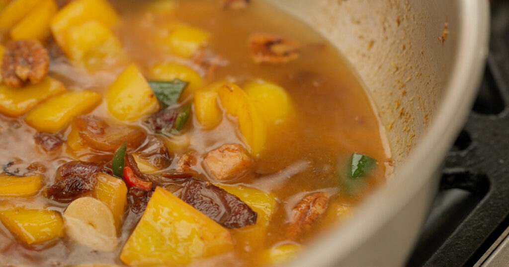 Ingredients in a pot with chicken stock added