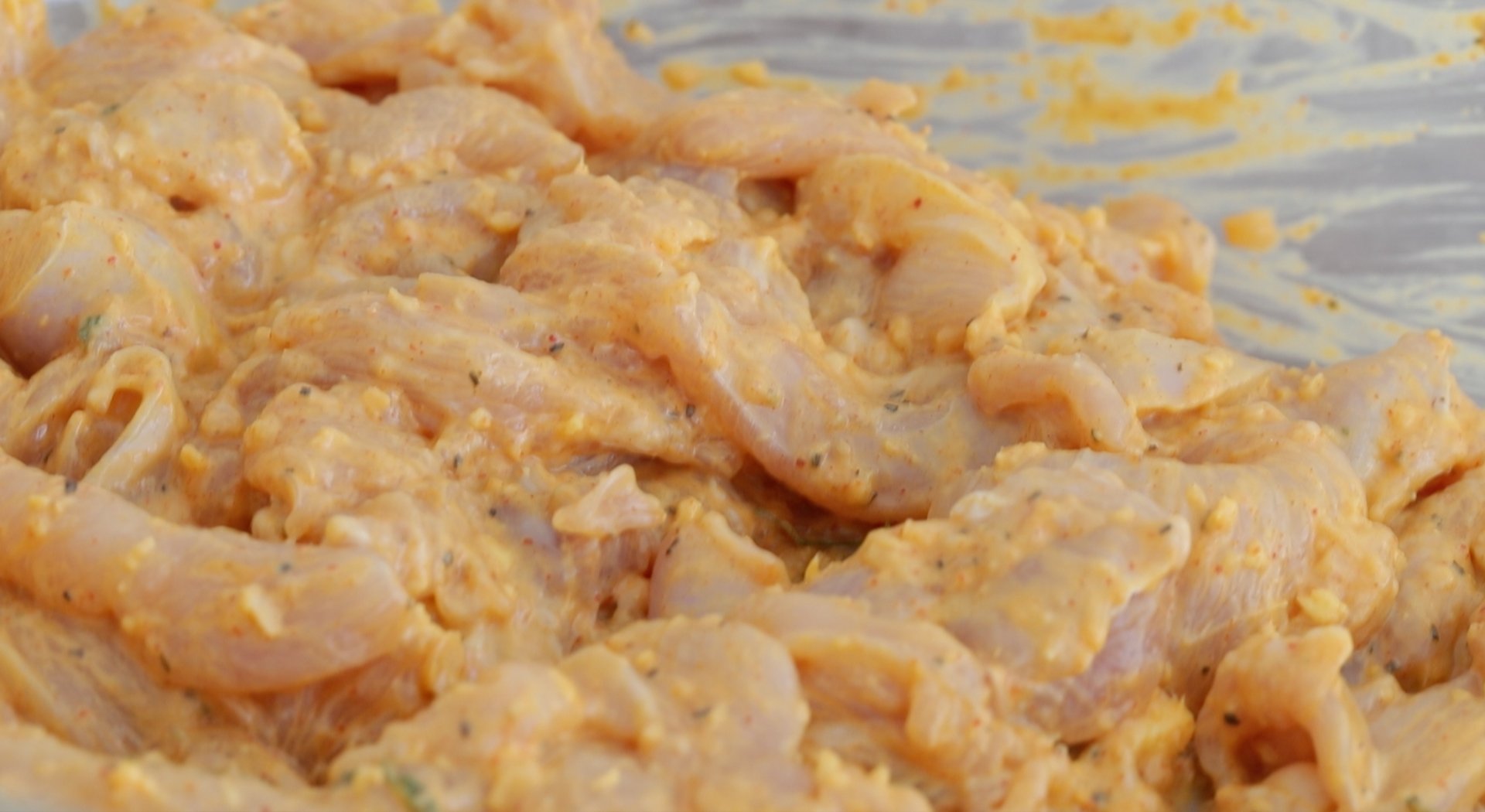 marinating chicken in a bowl