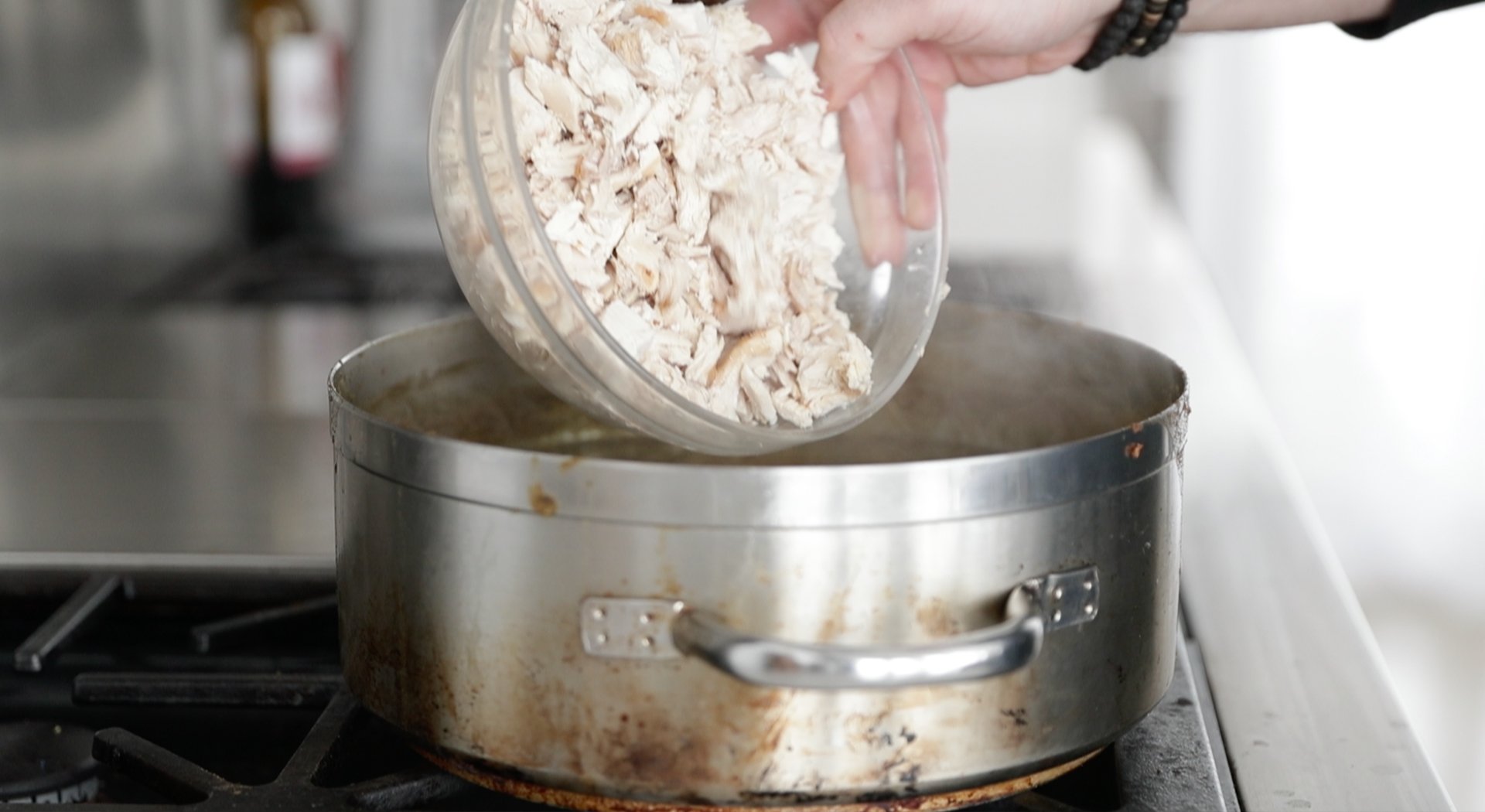 adding chopped chicken to chili