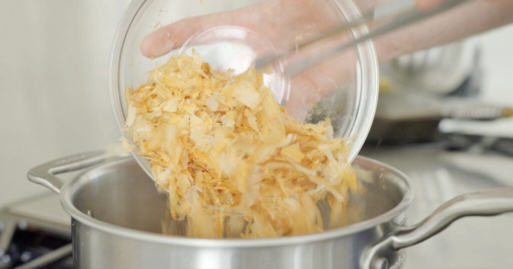 Pouring bonito flakes into a pot