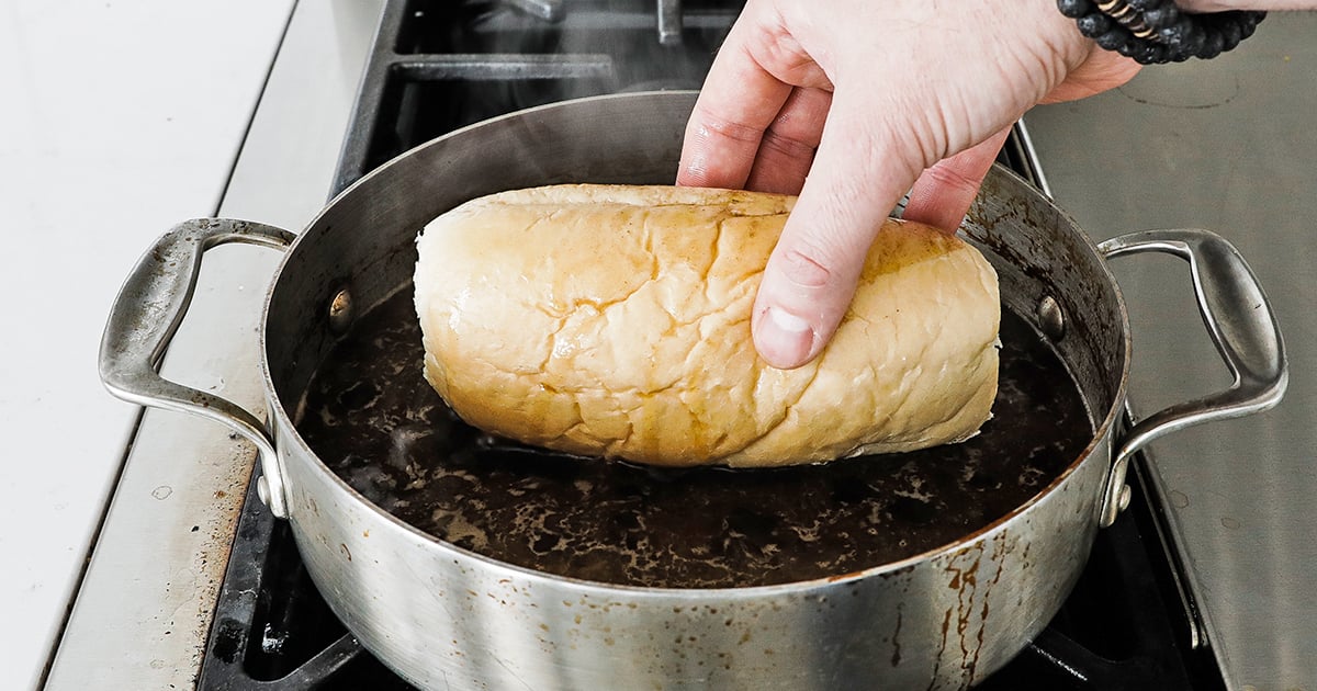 dipping the top part of the bun in au jus