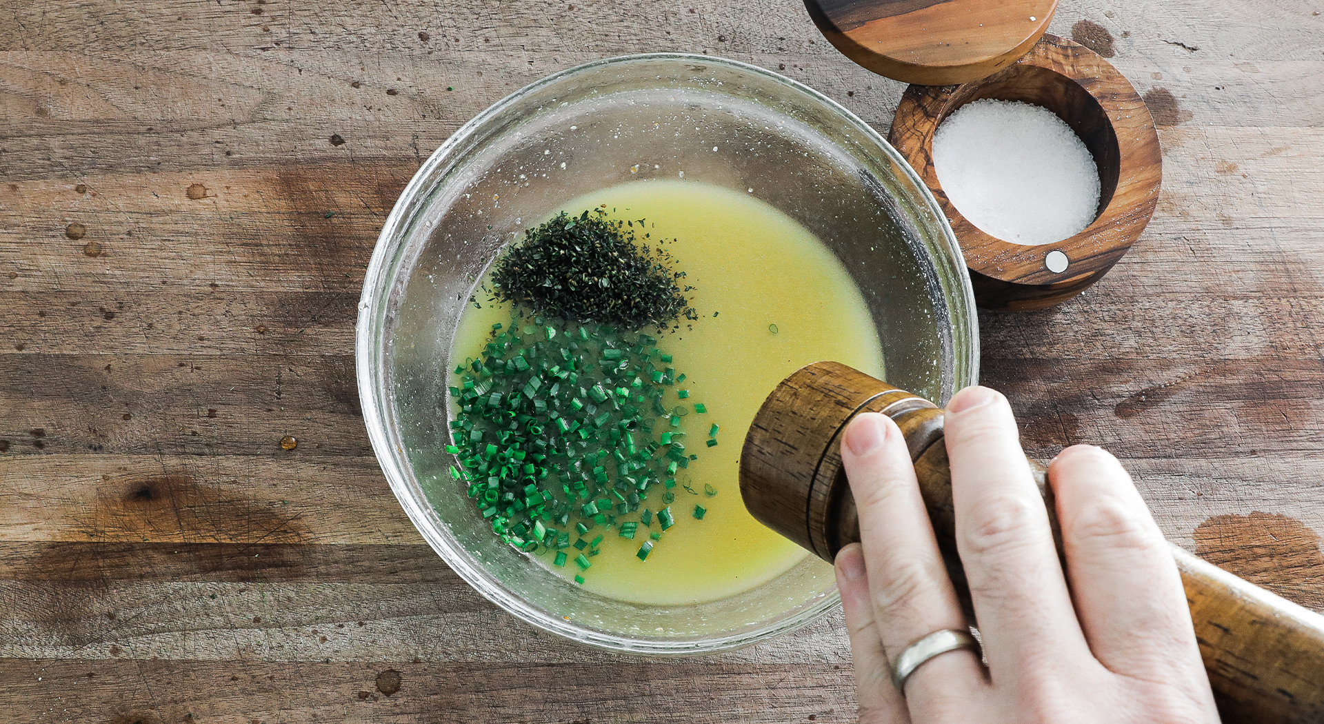 adding herbs and seasonings to a vinaigrette