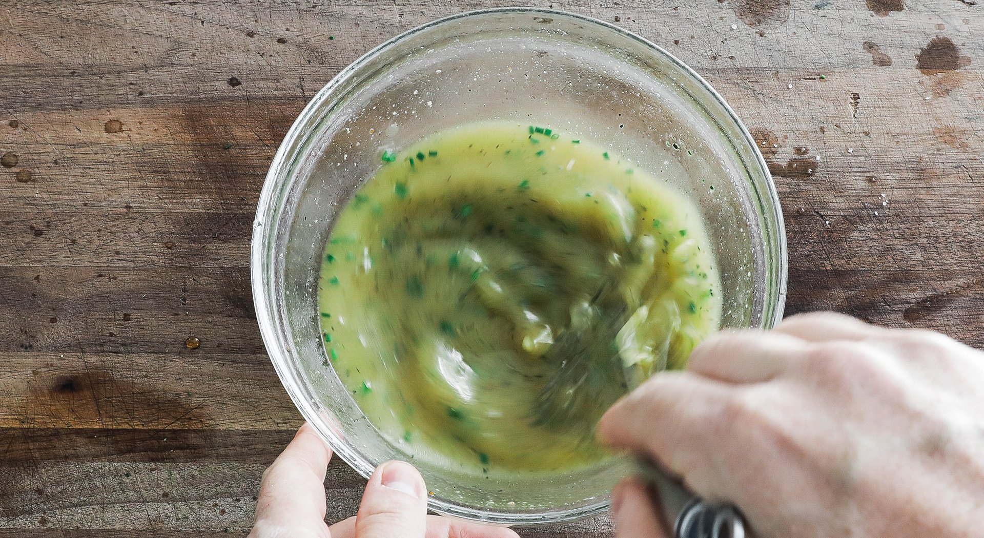 whisking together a lemon vinaigrette