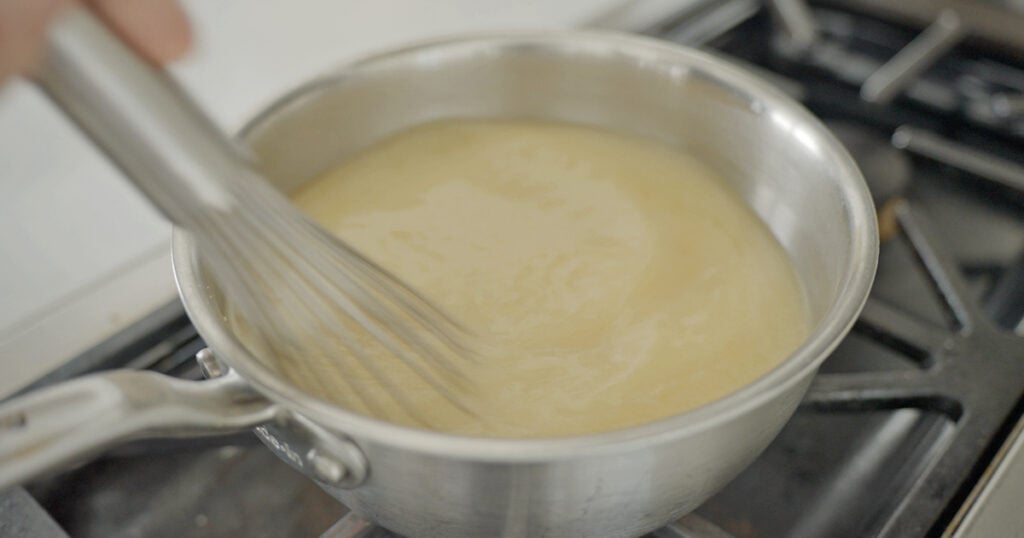 Soup in a pan with a whisk