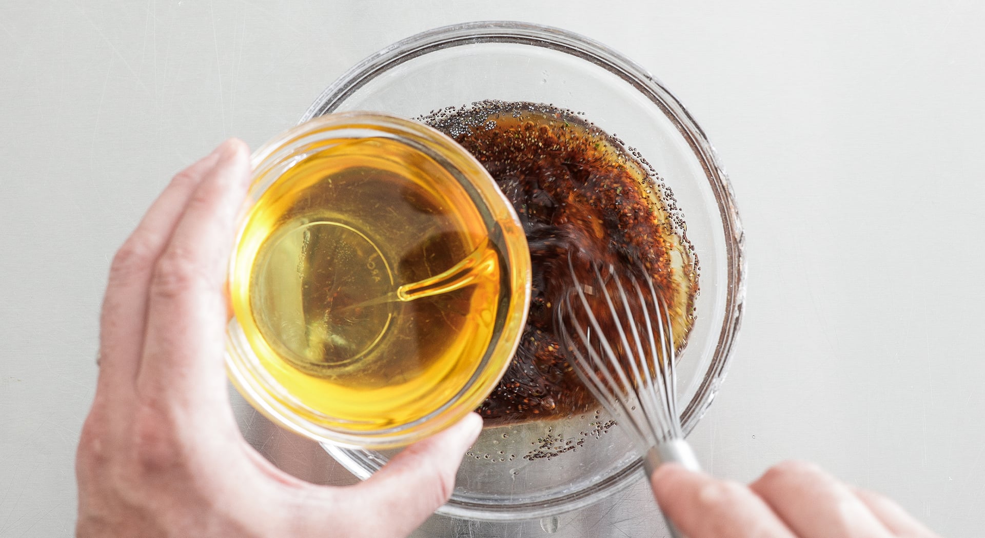 adding oil to a dressing