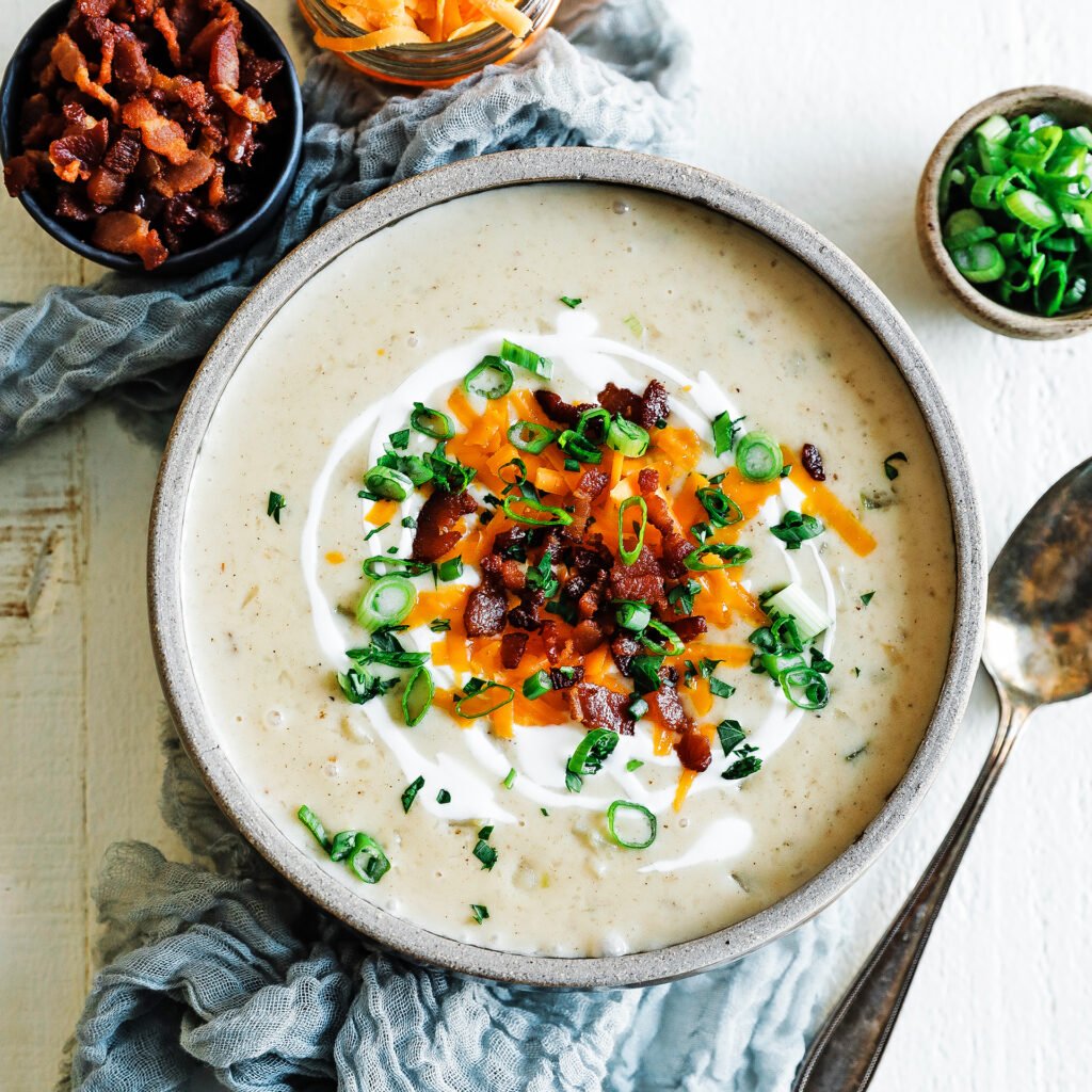 bowl of potato soup with toppings