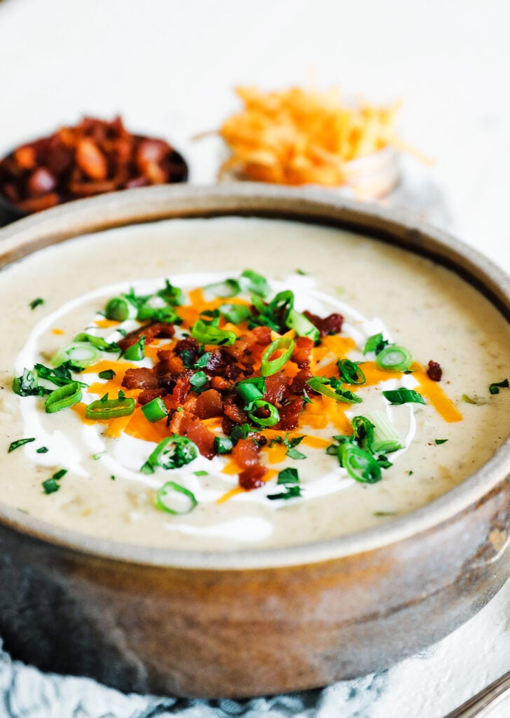 bowl of potato soup with toppings