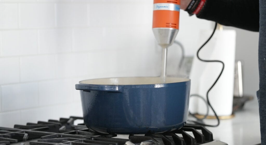 pureeing potato soup with a hand blender