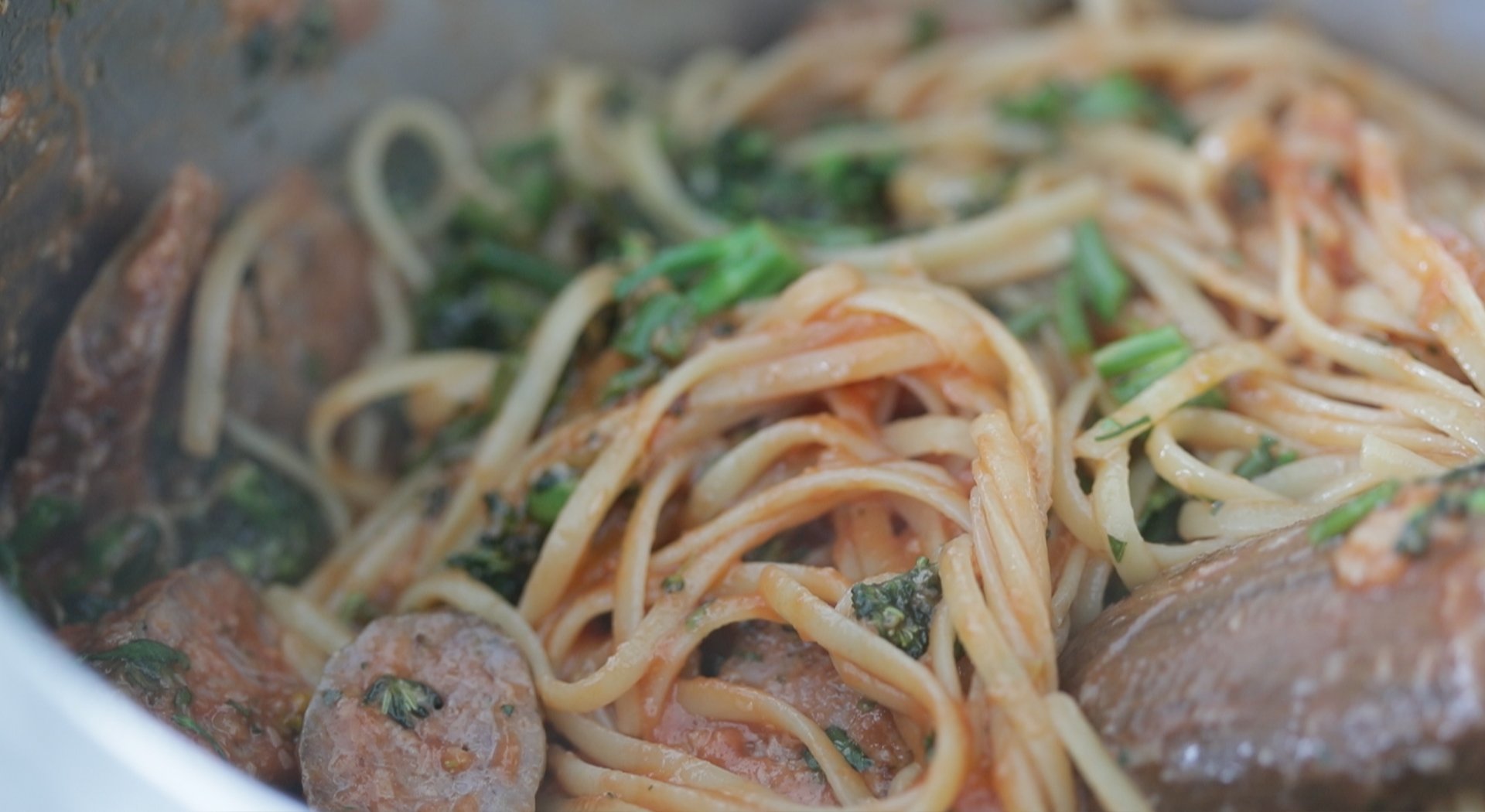 mixing pasta with veggies