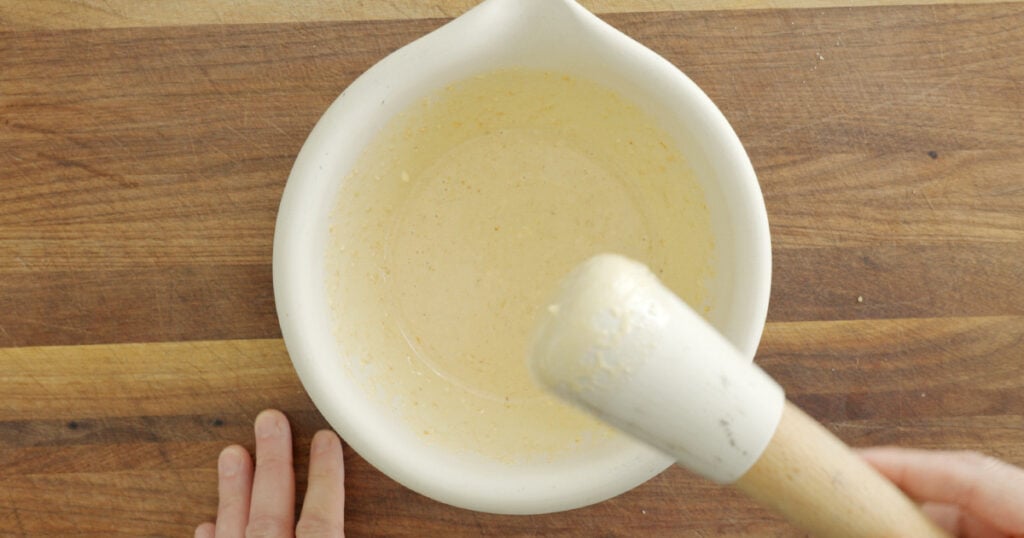 mortar ands pestle with finished sesame dressing