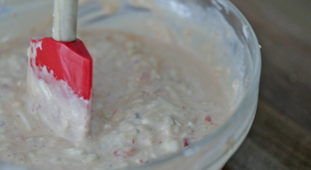 whisking together a bowl of thousand island dressing