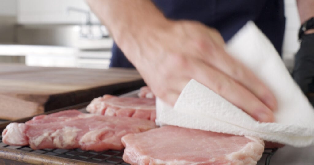 Drying pork with a paper towel