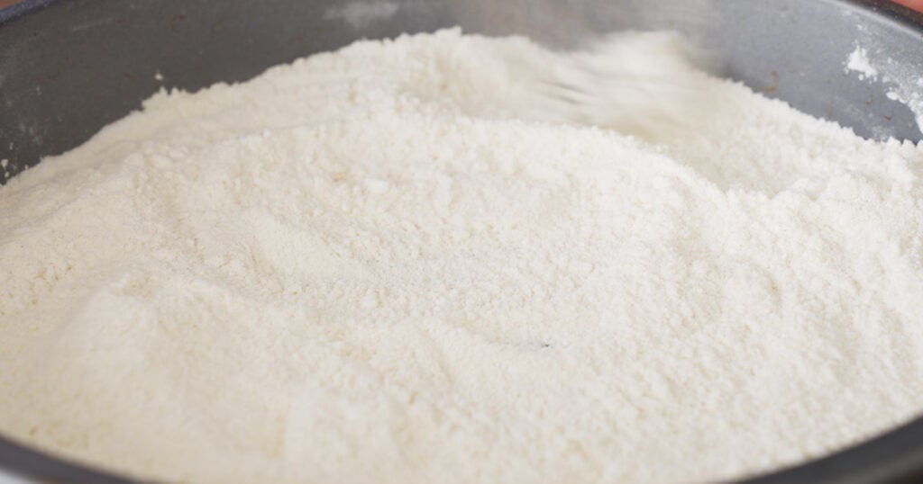 Close up of a tin filled with flour and potato starch 