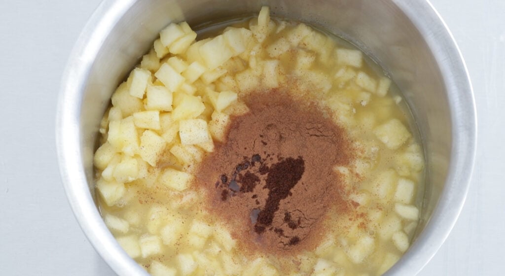 pineapple, pineapple juice, brown sugar, cinnamon, and cloves mix in a medium size pot