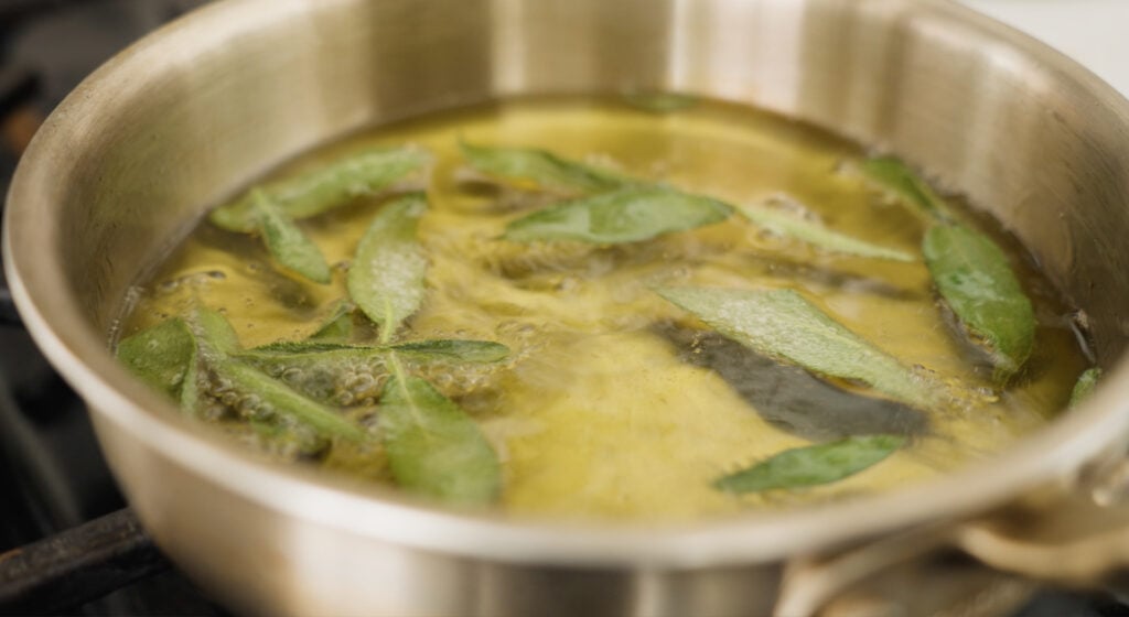 Sage in a small pot of oil