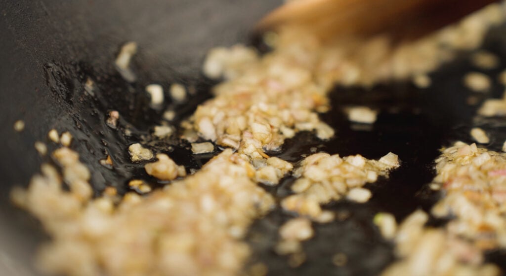 Garlic and shallots browning in a skillet