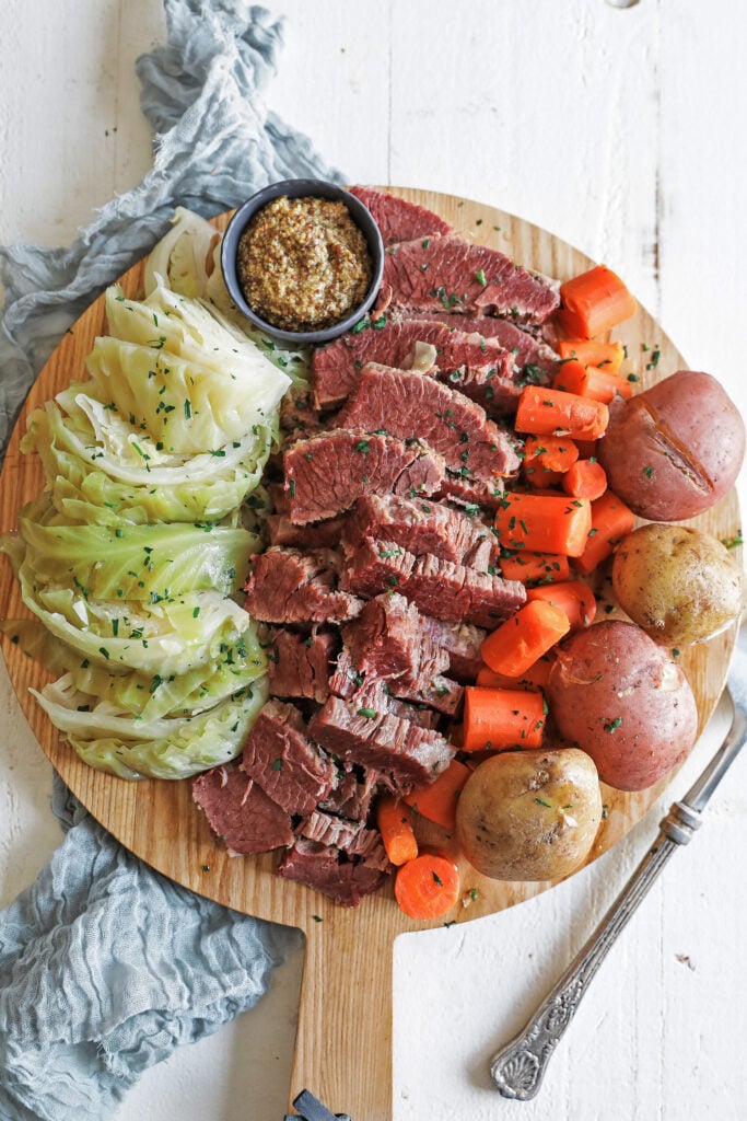 platter of sliced corned beef and vegetables