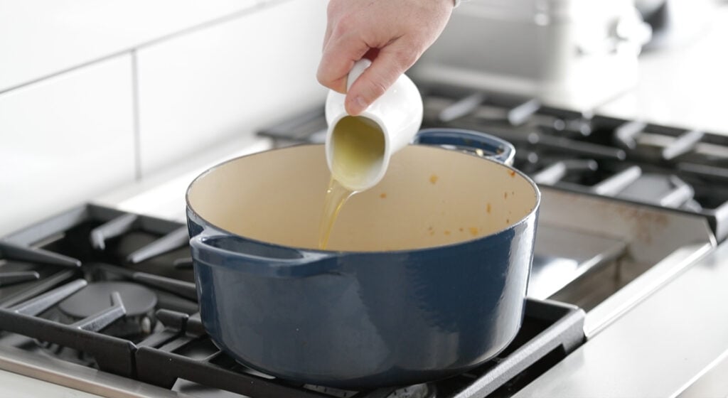 pouring olive oil in a pot
