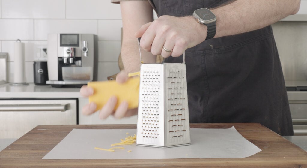 shredding cheese using a box grater