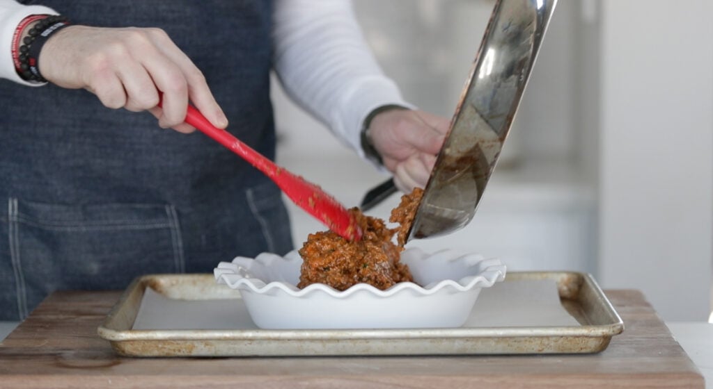 adding shepherd's pie stuffing to a pie casserole dish