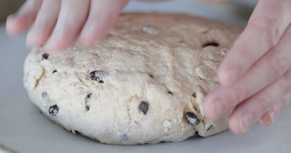 pressing down soda bread dough