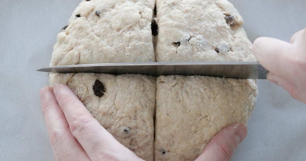 slicing soda bread dough before baking