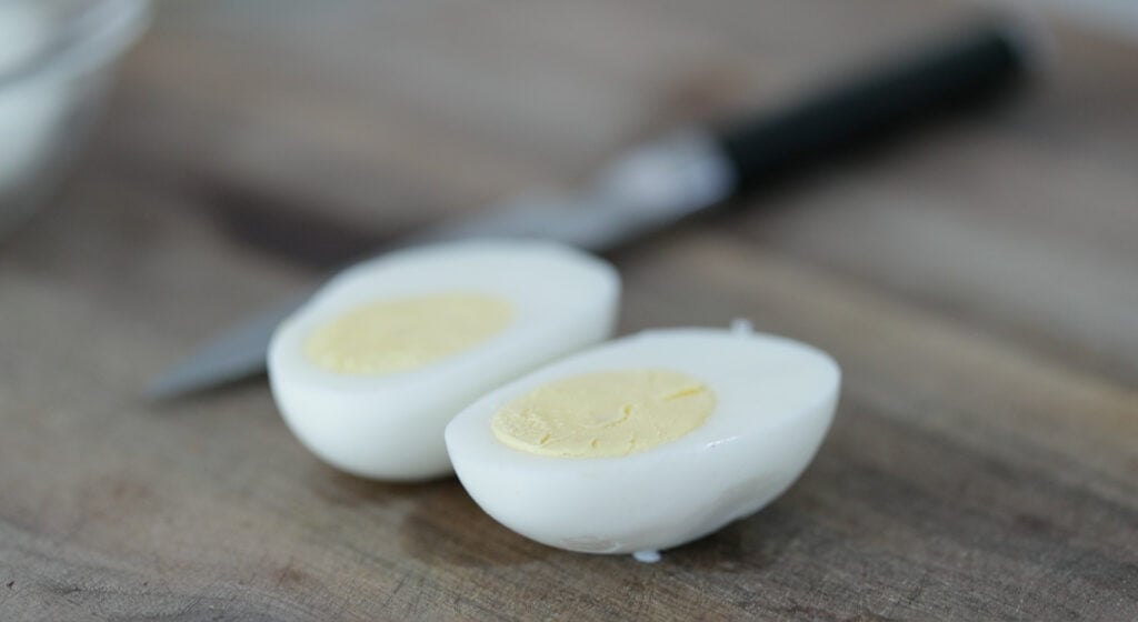 slicing a hard boiled egg in half