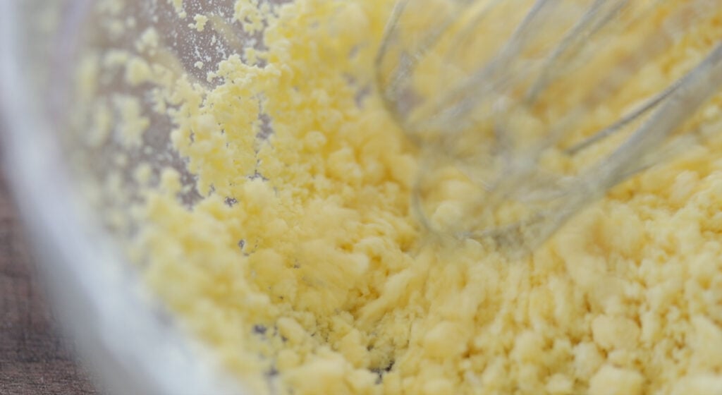 mashing hard boiled egg yolks with a whisk