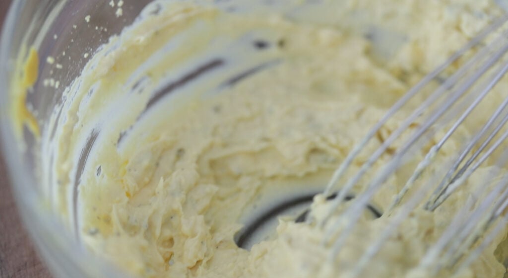 whisking a southern deviled egg filling