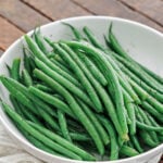 Cooked Green Beans in a white serving bowl