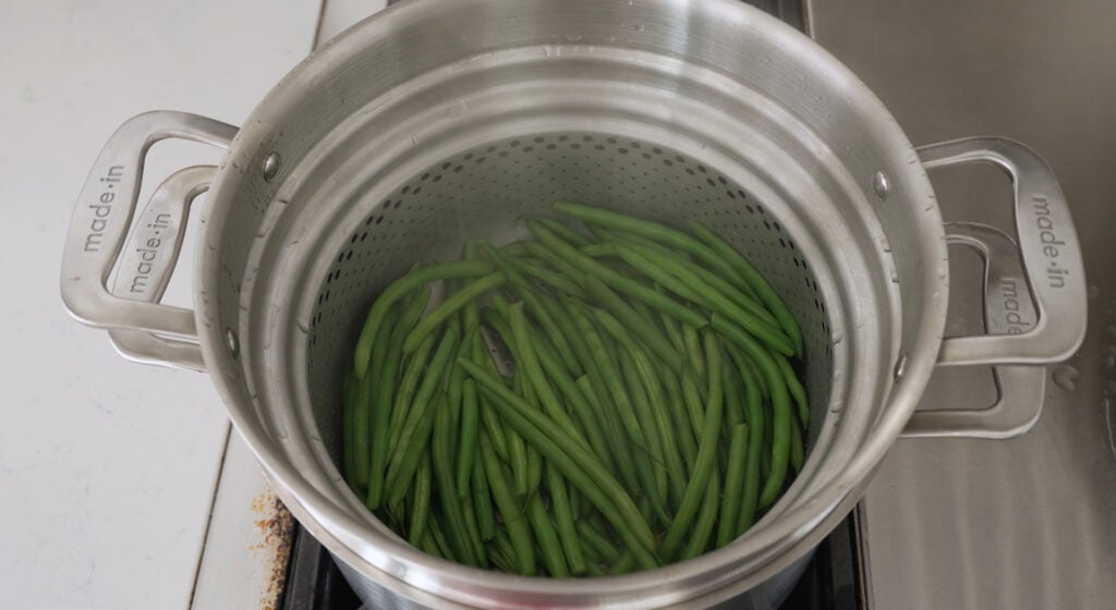 Beans inside an insert in a large pot