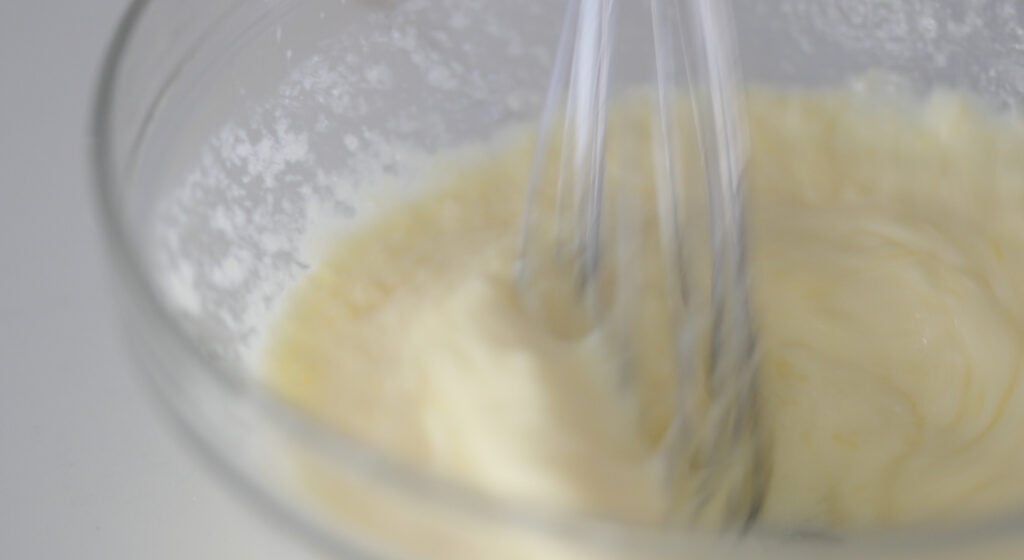 whisking together eggs and buttermilk in a bowl