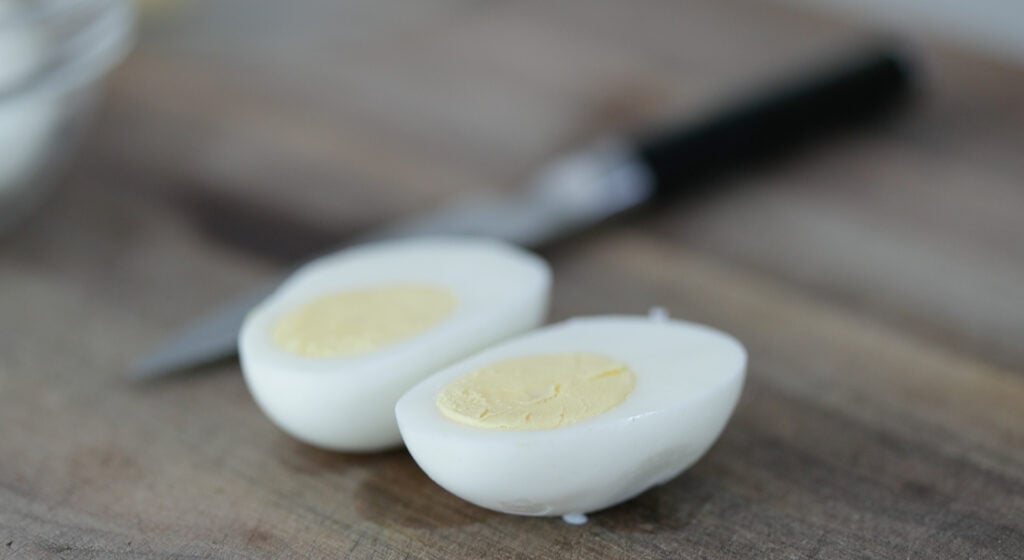 slicing hard boiled eggs in half