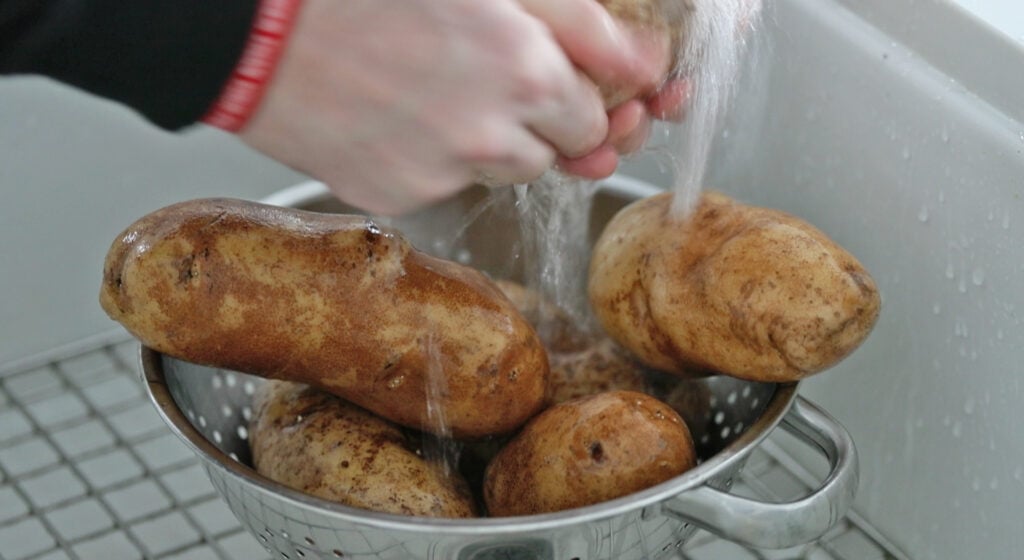 washing potatoes in the sink