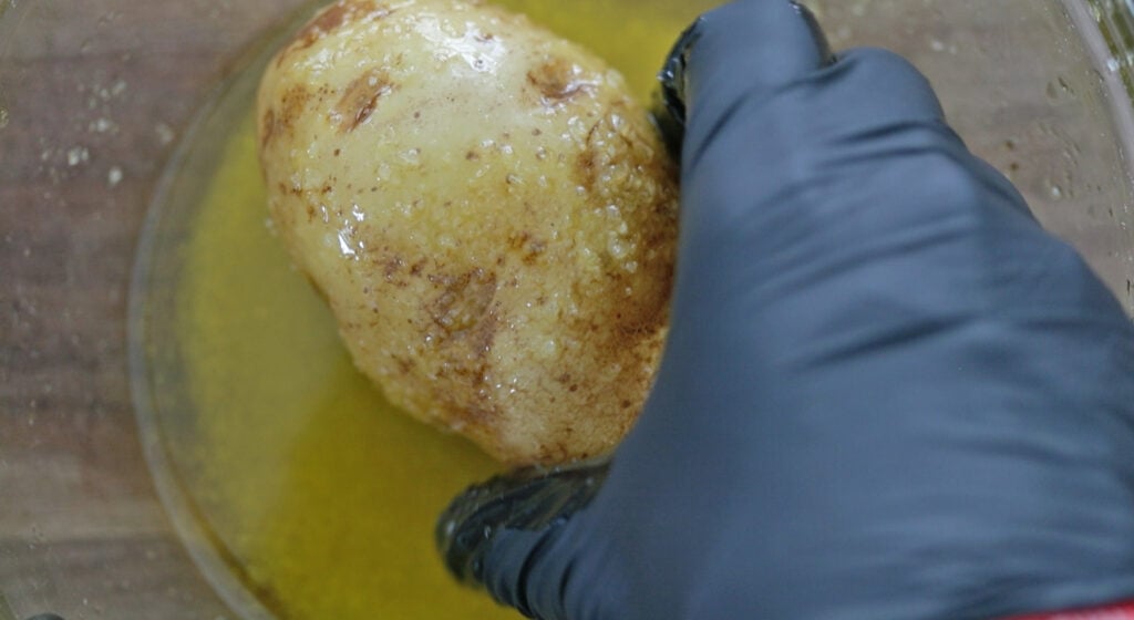 coating a potato in oil and salt
