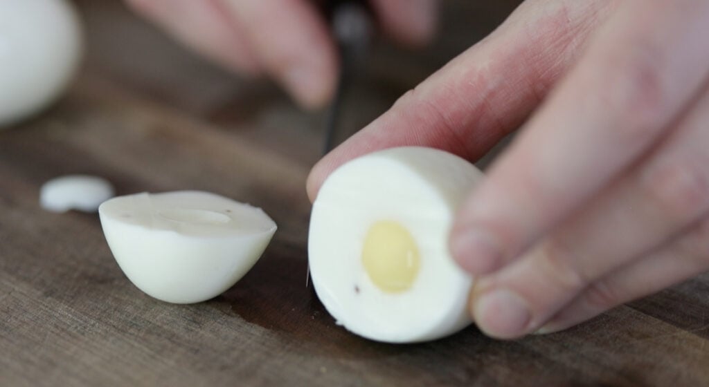 slicing a hard boiled egg