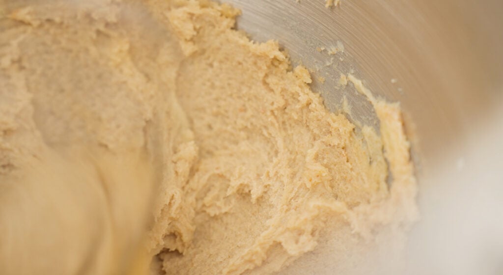 Brown butter and sugars mixed together in a mixing bowl 
