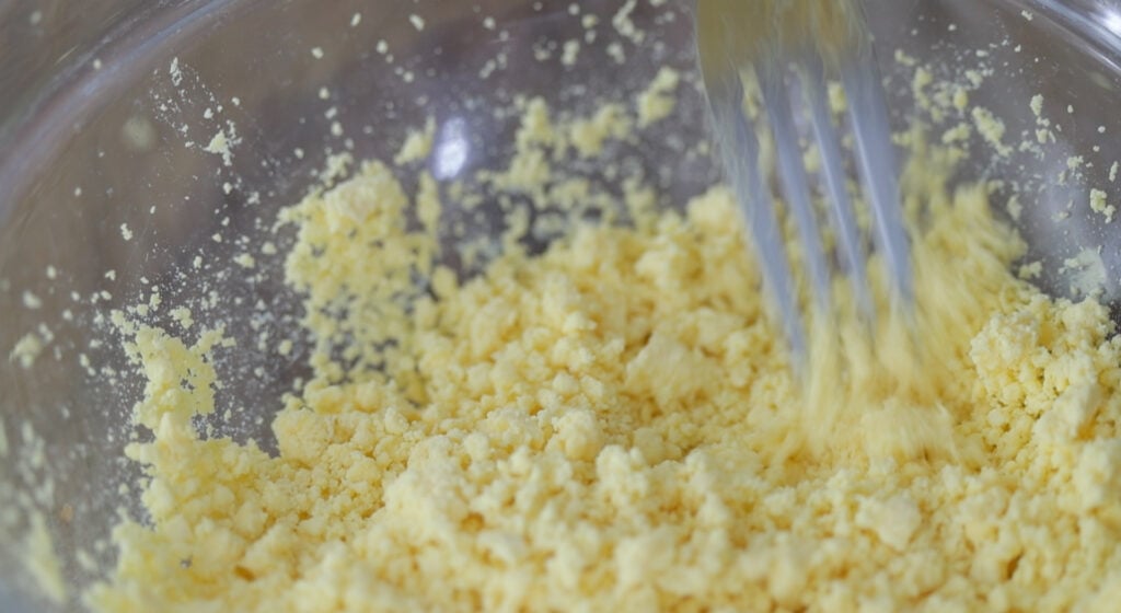 mashing egg yolks in a bowl