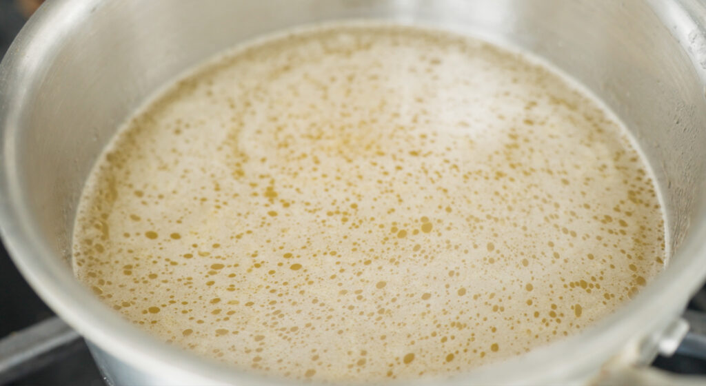 Pot with chicken stock added