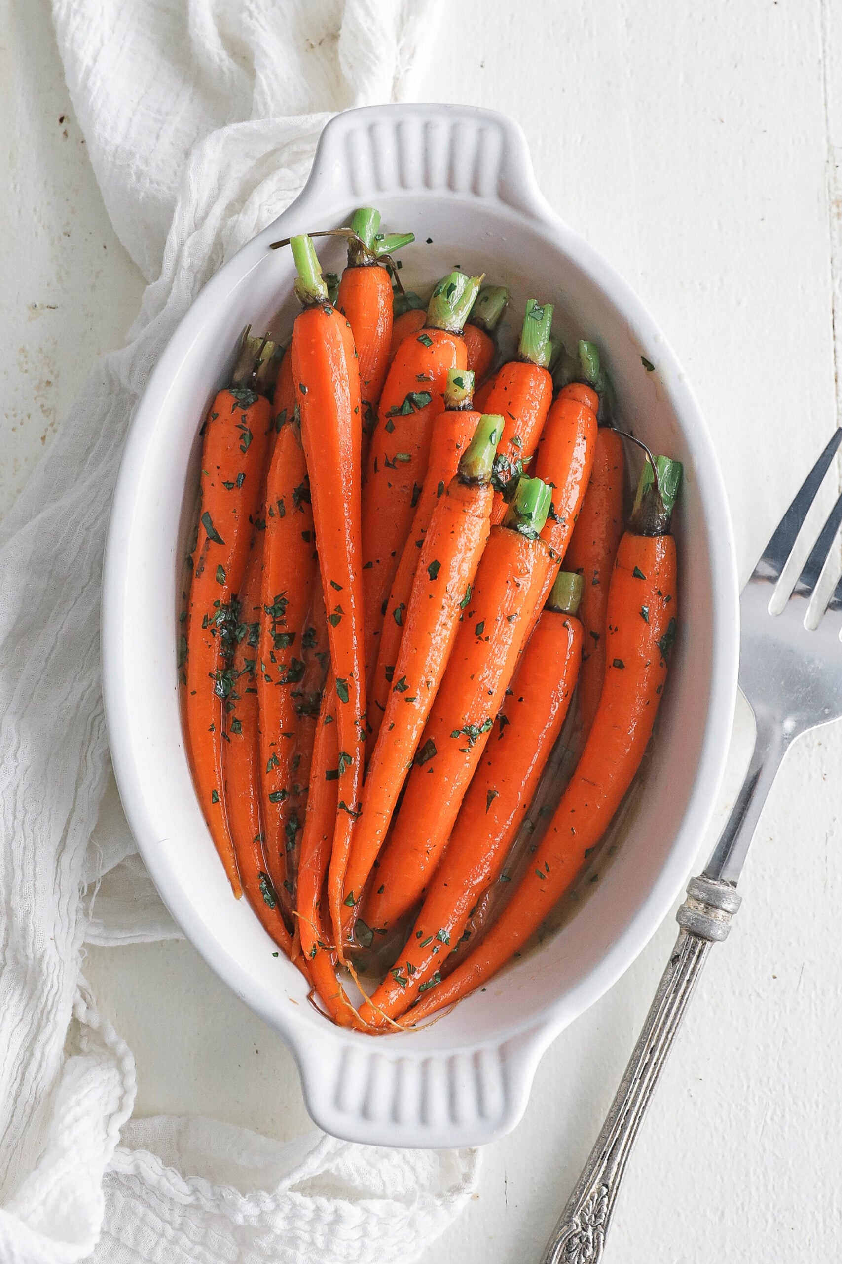 butter glazed baby carrots in a casserole dish