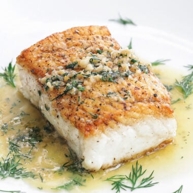 halibut on a plate with butter dill sauce