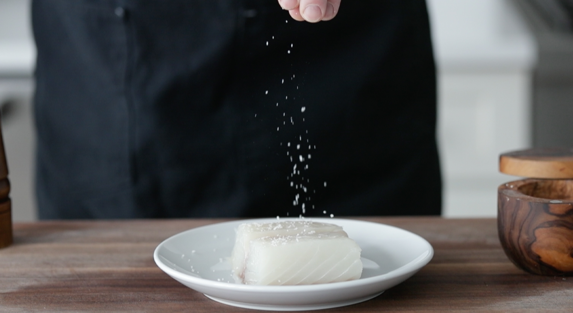 seasoning a fresh halibut fish fillet