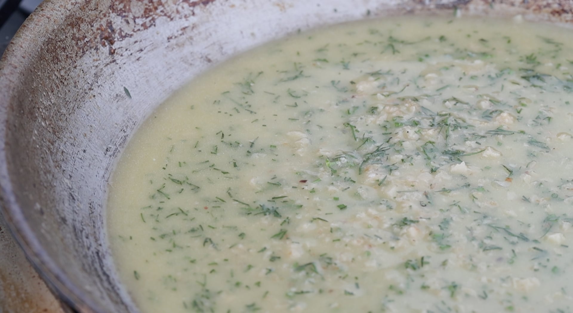 adding fresh dill to a butter sauce in a pan